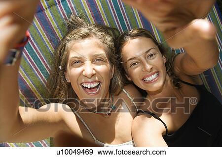 Caucasian mid-adult women being silly in hammock. View Large Photo Image Stock Photo - Caucasian mid-adult women being silly in hammock.. Fotosearch