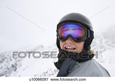 Caucasian teenage boy skier in helmet and goggles at ski resort on mountain. View Large Photo Image Stock Photo - Caucasian teenage boy skier in helmet and goggles at ski resort on mountain.. Fotosearch