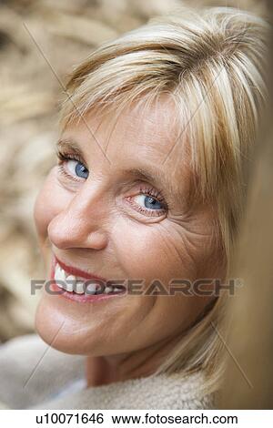 Stock Photograph - Head shot of middle-aged Caucasian woman smiling.. Fotosearch
