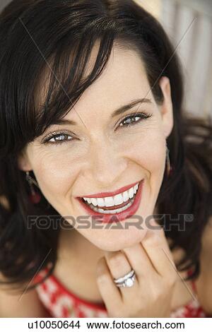 Mid-adult Caucasian woman smiling wearing wedding ring. View Large Photo Image Picture - Mid-adult Caucasian woman smiling wearing wedding ring.. Fotosearch