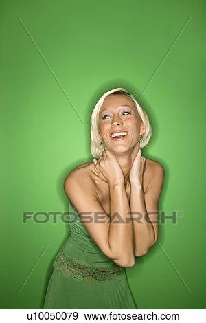 Portrait of smiling young adult Caucasian blond woman on green background wearing green sundress. View Large Photo Image Stock Photo - Portrait of smiling young adult Caucasian blond woman on green background wearing green sundress.. Fotosearch