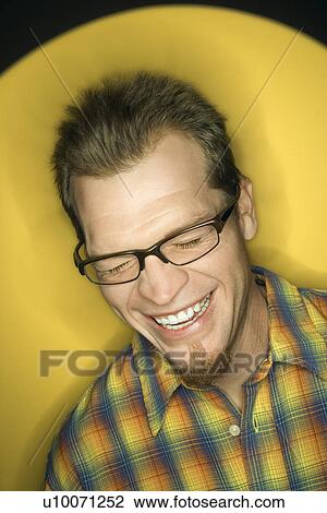 Vignette of adult Caucasian man on yellow background laughing. View Large Photo Image Stock Image - Vignette of adult Caucasian man on yellow background laughing.. Fotosearch
