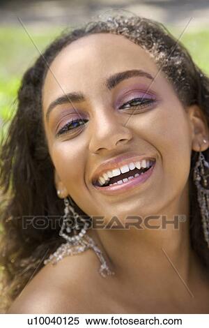 Young-adult Black woman laughing and making eye contact. View Large Photo Image Stock Photography - Young-adult Black woman laughing and making eye contact.. Fotosearch