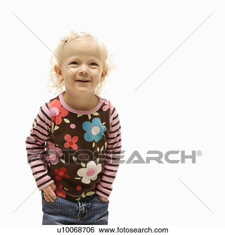 Stock Photograph - Young Caucasian female toddler with hands in her pockets and laughing.. Fotosearch