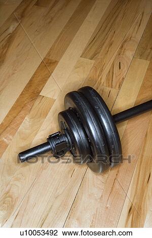 Barbell with weights on gym floor. View Large Photo Image Stock Image - Barbell with weights on gym floor.. Fotosearch