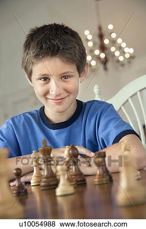 Caucasian pre-teen boy playing chess. View Large Photo Image Stock Photo - Caucasian pre-teen boy playing chess.. Fotosearch
