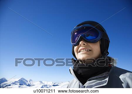 Caucasian teenage boy snowboarder wearing helmet and goggles on mountain. View Large Photo Image Stock Image - Caucasian teenage boy snowboarder wearing helmet and goggles on mountain.. Fotosearch