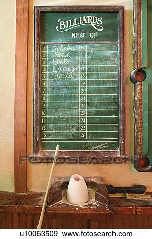 Stock Photo - Chalkboard queue for people waiting to play billiards in nightclub with chalk and pool stick.. Fotosearch