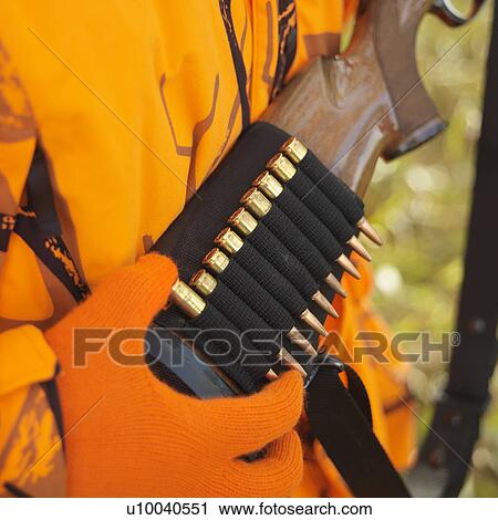 Close-up of hunter removing bullet from ammo holder on rifle. View Large Photo Image Stock Image - Close-up of hunter removing bullet from ammo holder on rifle.. Fotosearch