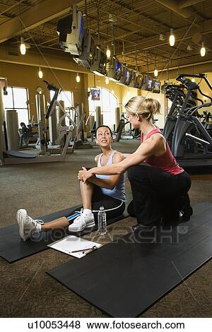 Prime adult Caucasian female with personal trainer at gym. View Large Photo Image Stock Photo - Prime adult Caucasian female with personal trainer at gym.. Fotosearch