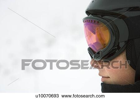 Profile of Caucasian teenage boy skier wearing helmet and goggles at ski resort on mountain. View Large Photo Image Stock Image - Profile of Caucasian teenage boy skier wearing helmet and goggles at ski resort on mountain.. Fotosearch
