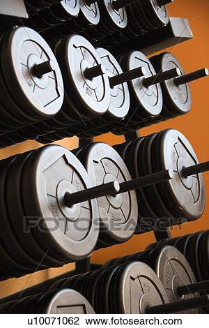 Stacked barbells with weights. View Large Photo Image Stock Image - Stacked barbells with weights.. Fotosearch