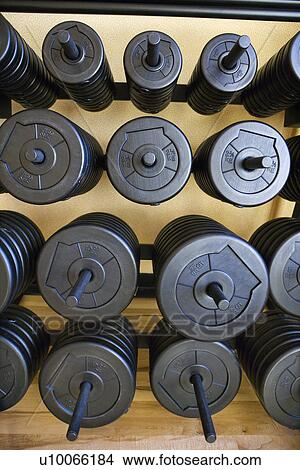 Picture - Stacks of barbell weights at gym.. Fotosearch