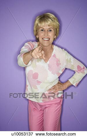 Caucasian mature adult female pointing at viewer and smiling. View Large Photo Image Stock Photo - Caucasian mature adult female pointing at viewer and smiling.. Fotosearch