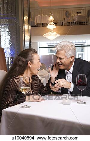 Picture - Caucasian mature adult male proposing to prime adult female.. Fotosearch