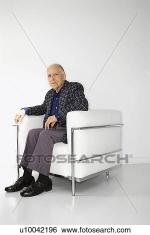 Caucasian mature adult male sitting in chair looking at viewer. View Large Photo Image Stock Photograph - Caucasian mature adult male sitting in chair looking at viewer.. Fotosearch