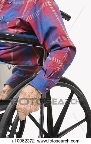 Caucasion male elderly hands gripping wheels of wheelchair. View Large Photo Image Stock Image - Caucasion male elderly hands gripping wheels of wheelchair.. Fotosearch