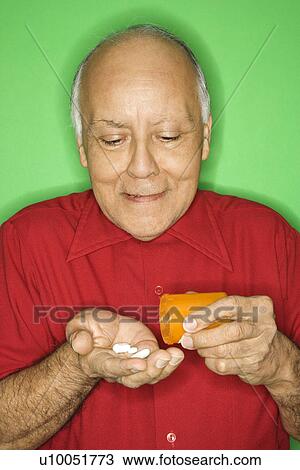 Mature adult Caucasian male emptying pill bottle into hand. View Large Photo Image Stock Image - Mature adult Caucasian male emptying pill bottle into hand.. Fotosearch