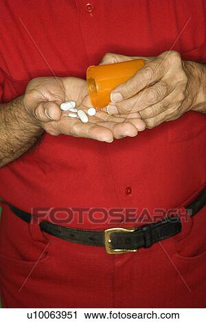 Mature adult Caucasian male emptying pill bottle into hand. View Large Photo Image Stock Image - Mature adult Caucasian male emptying pill bottle into hand.. Fotosearch