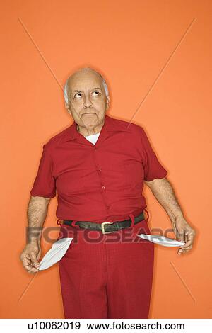 Mature adult Caucasian male pulling out empty pockets. View Large Photo Image Stock Photo - Mature adult Caucasian male pulling out empty pockets.. Fotosearch
