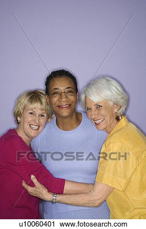 Stock Image - Portrait of Caucasian and African American mature adult females.. Fotosearch