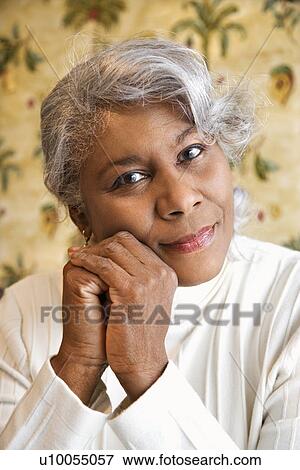 Stock Photo - Portrait of mature African American woman looking at viewer.. Fotosearch