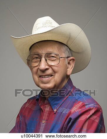 Portrait of smiling Caucasion elderly man wearing plaid shirt and cowboy hat. View Large Photo Image Stock Image - Portrait of smiling Caucasion elderly man wearing plaid shirt and cowboy hat.. Fotosearch