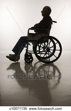 Stock Photography - Profile view of silhouetted Caucasion elderly man sitting in wheelchair.. Fotosearch