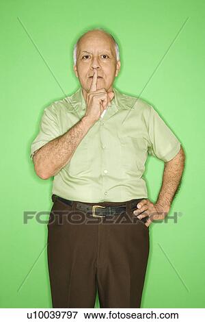 Caucasian mature adult male with finger up to mouth. View Large Photo Image Stock Photo - Caucasian mature adult male with finger up to mouth.. Fotosearch