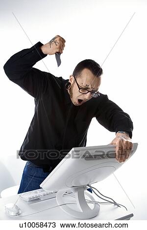 Caucasian mid-adult man with tattoos and piercings stabbing computer with knife. View Large Photo Image Stock Image - Caucasian mid-adult man with tattoos and piercings stabbing computer with knife.. Fotosearch