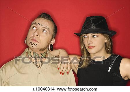 Caucasian teen female looking at mid-adult man who is looking away. View Large Photo Image Picture - Caucasian teen female looking at mid-adult man who is looking away.. Fotosearch