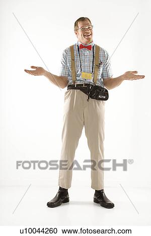 Stock Image - Caucasian young man dressed like nerd shrugging his shoulders.. Fotosearch