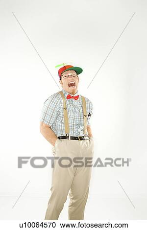 Caucasian young man dressed like nerd wearing propeller cap with hands in pockets looking at viewer with mouth open. View Large Photo Image Stock Image - Caucasian young man dressed like nerd wearing propeller cap with hands in pockets looking at viewer with mouth open.. Fotosearch