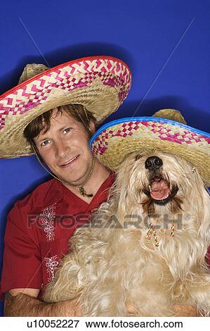 Fluffy brown dog and Caucasian male young adult wearing Mexican sombreros. View Large Photo Image Stock Photo - Fluffy brown dog and Caucasian male young adult wearing Mexican sombreros.. Fotosearch