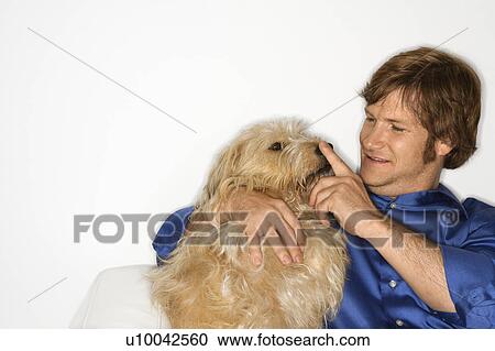 Male Caucasian young adult with fluffy brown dog. View Large Photo Image Stock Image - Male Caucasian young adult with fluffy brown dog.. Fotosearch