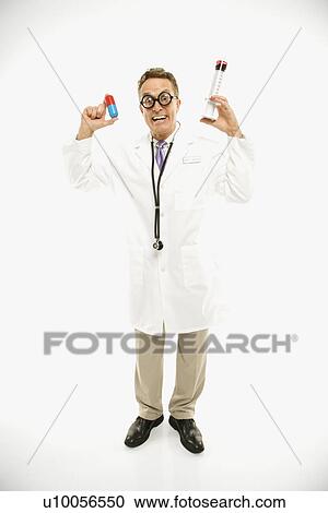 Mid-adult Caucasian male doctor wearing eyeglasses holding an oversized medical pill and syringe. View Large Photo Image Stock Image - Mid-adult Caucasian male doctor wearing eyeglasses holding an oversized medical pill and syringe.. Fotosearch