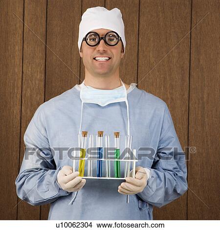 Mid-adult Caucasian male surgeon wearing thick glasses and holding test tube tray. View Large Photo Image Picture - Mid-adult Caucasian male surgeon wearing thick glasses and holding test tube tray.. Fotosearch