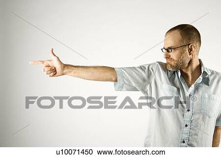 Portrait of Caucasian man holding hand out like a gun standing against white background. View Large Photo Image Stock Image - Portrait of Caucasian man holding hand out like a gun standing against white background.. Fotosearch