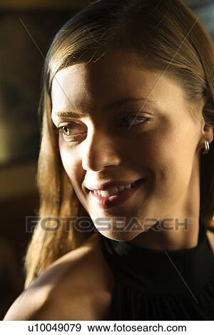 Stock Photo - Close-up portrait of smiling young caucasian woman.. Fotosearch