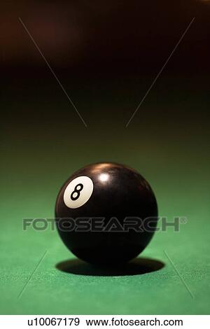 Stock Photo - Eight ball on green billiards table.. Fotosearch