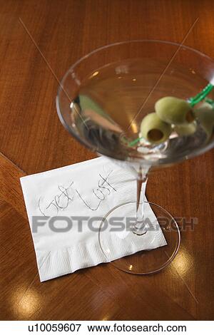 Stock Photo - Martini and note on napkin reading 'get lost. '. Fotosearch