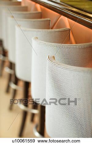 Stock Photo - Stools lined up at bar.. Fotosearch