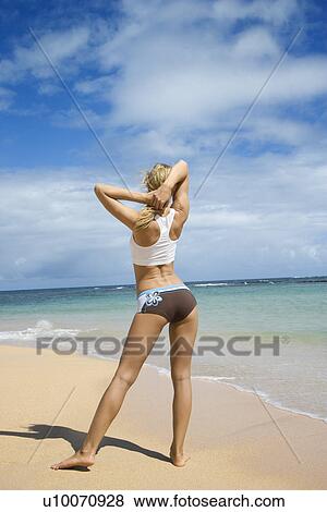 Caucasian young adult woman stretching on beach. View Large Photo Image Stock Photo - Caucasian young adult woman stretching on beach.. Fotosearch