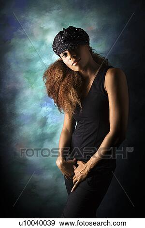 Studio portrait of hip African-American young adult woman looking at viewer. View Large Photo Image Stock Photo - Studio portrait of hip African-American young adult woman looking at viewer.. Fotosearch