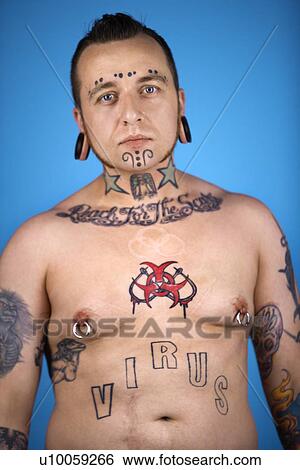 Stock Photograph - Barechested Caucasian mid-adult man with tattoos and piercings.. Fotosearch