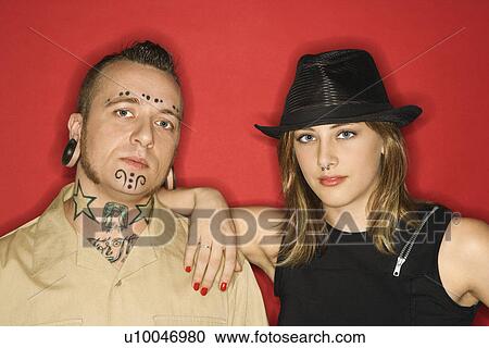 Stock Image - Caucasian mid-adult man and teen female standing together looking at viewer.. Fotosearch