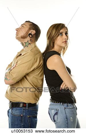 Caucasian mid-adult man and teen female standing back to back. View Large Photo Image Stock Image - Caucasian mid-adult man and teen female standing back to back.. Fotosearch