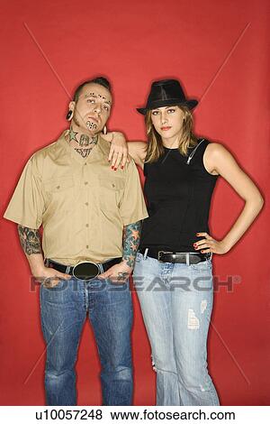 Stock Photo - Caucasian mid-adult man and teen female standing together looking at viewer.. Fotosearch
