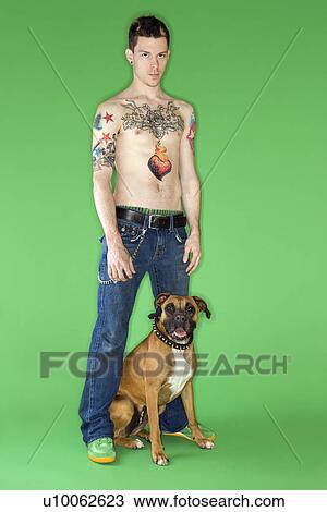 Young adult Caucasian male with Boxer dog. View Large Photo Image Stock Image - Young adult Caucasian male with Boxer dog.. Fotosearch