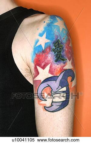 Stock Photography - Young adult Caucasian male with tattoos on shoulder.. Fotosearch